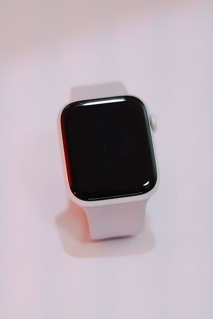 headline Close-up of a white smartwatch with a blank screen on a soft, light background.